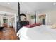 A spacious main bedroom offering a view into the bathroom, hardwood floors, and access to the kitchen at 4499 Highway 308, Aynor, SC 29544