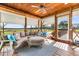 Inviting covered porch with comfortable seating, stylish rug and wooded views at 4499 Highway 308, Aynor, SC 29544
