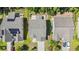 Aerial view showcasing the roof lines, patios, fences and landscaping of three homes in a residential neighborhood at 4501 Farm Lake Dr., Myrtle Beach, SC 29579