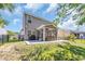 Expansive backyard featuring a patio, screened porch, lush lawn, and a black fence for added privacy at 4501 Farm Lake Dr., Myrtle Beach, SC 29579