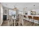Dining room with a stylish light fixture, large table, and an open view of the breakfast bar area at 4501 Farm Lake Dr., Myrtle Beach, SC 29579