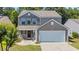 Charming two-story home featuring a two-car garage, and a beautifully landscaped front yard at 4501 Farm Lake Dr., Myrtle Beach, SC 29579