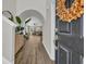 A welcoming foyer featuring a wood-look floor that leads to the arched entryway to the living room at 4501 Farm Lake Dr., Myrtle Beach, SC 29579
