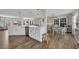 Kitchen with a large island, breakfast bar, white cabinets, and modern light fixtures overlooking dining area at 4501 Farm Lake Dr., Myrtle Beach, SC 29579