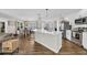 Bright open kitchen with a large island, bar seating, stainless appliances, and modern pendant lighting at 4501 Farm Lake Dr., Myrtle Beach, SC 29579