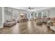 Spacious living room featuring a wood-look floor, a ceiling fan and large windows at 4501 Farm Lake Dr., Myrtle Beach, SC 29579