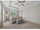 Bright bedroom featuring a ceiling fan, large window, and neutral decor for a relaxing atmosphere at 4501 Farm Lake Dr., Myrtle Beach, SC 29579