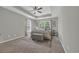 Serene main bedroom features neutral tones, tray ceiling, and soft natural lighting from large windows at 4501 Farm Lake Dr., Myrtle Beach, SC 29579