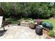 Charming backyard patio with cozy fire pit, surrounded by meticulously landscaped plants and stone accents at 513 Westham Dr., Murrells Inlet, SC 29576