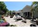 Spacious backyard patio features ample seating, a fire pit, and lush landscaping for relaxation and entertainment at 513 Westham Dr., Murrells Inlet, SC 29576