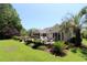 Expansive backyard patio is enhanced by a fire pit, meticulous landscaping, and comfortable seating at 513 Westham Dr., Murrells Inlet, SC 29576