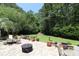 Landscaped backyard patio with a fire pit, outdoor seating, and lush greenery for peaceful relaxation at 513 Westham Dr., Murrells Inlet, SC 29576