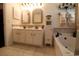 Well-lit bathroom offering double sinks, granite counters, a soaking tub, and storage at 513 Westham Dr., Murrells Inlet, SC 29576