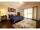 Comfortable bedroom boasting wood floors, neutral walls, and sliding glass door to the exterior at 513 Westham Dr., Murrells Inlet, SC 29576