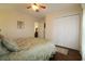 Cozy bedroom featuring a ceiling fan, light yellow walls, and spacious closet for ample storage at 513 Westham Dr., Murrells Inlet, SC 29576