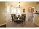Cozy dining area with decorative wallpaper, bright windows, and elegant lighting at 513 Westham Dr., Murrells Inlet, SC 29576