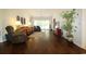 Cozy living room featuring hardwood floors, a ceiling fan, and large windows at 513 Westham Dr., Murrells Inlet, SC 29576