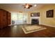 Bright living room with fireplace, hardwood floors and access to the enclosed porch through sliding glass doors at 513 Westham Dr., Murrells Inlet, SC 29576