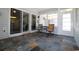 Enclosed porch with multi-tone slate tile flooring and comfortable seating, perfect for relaxing outdoors at 513 Westham Dr., Murrells Inlet, SC 29576