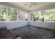 Comfortable enclosed porch featuring slate flooring, white wood trim, and an abundance of natural light at 513 Westham Dr., Murrells Inlet, SC 29576