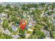 Aerial view of a residential area surrounded by lush greenery, blue ocean, and a red location pin at 514 6Th Ave. S, Surfside Beach, SC 29575
