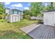 Landscaped backyard with a storage shed and wooden deck at 514 6Th Ave. S, Surfside Beach, SC 29575