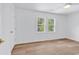 Bright bedroom featuring two windows, light wood flooring, and a ceiling fan at 514 6Th Ave. S, Surfside Beach, SC 29575