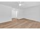 Spacious bedroom with wood-look flooring, a ceiling fan, ample closet space, and bright neutral walls at 514 6Th Ave. S, Surfside Beach, SC 29575