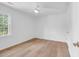 Clean bedroom with light wood flooring, white walls, and a bright window at 514 6Th Ave. S, Surfside Beach, SC 29575