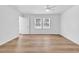 Bright bedroom with wood-look flooring, a ceiling fan, neutral walls, and natural light from large windows at 514 6Th Ave. S, Surfside Beach, SC 29575