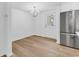 Dining area with hardwood floors and a stainless steel refrigerator at 514 6Th Ave. S, Surfside Beach, SC 29575