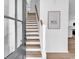 Bright entryway featuring light wood stairs with white risers, complemented by modern decor and wood-look floors at 514 6Th Ave. S, Surfside Beach, SC 29575