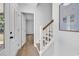 Inviting entryway with a white front door, wood-look flooring, and stairs leading to the upper level at 514 6Th Ave. S, Surfside Beach, SC 29575