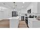 Open-concept kitchen with stainless appliances, island and hanging lights at 514 6Th Ave. S, Surfside Beach, SC 29575