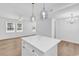 Open-concept kitchen with a white island and modern light fixtures at 514 6Th Ave. S, Surfside Beach, SC 29575