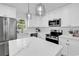 Modern white kitchen featuring an island and stainless steel appliances at 514 6Th Ave. S, Surfside Beach, SC 29575