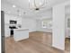 Open-concept kitchen with stainless steel appliances and hardwood floors at 514 6Th Ave. S, Surfside Beach, SC 29575