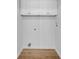 Clean laundry room featuring overhead cabinets, hookups, and wood-look flooring at 514 6Th Ave. S, Surfside Beach, SC 29575