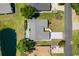 Overhead view of a single-story home with a gray roof and an expansive driveway, nestled next to a serene pond at 578 Circle Dr., Myrtle Beach, SC 29575