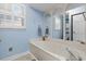 Bathroom featuring a relaxing tub, arched mirrors and lots of natural light at 578 Circle Dr., Myrtle Beach, SC 29575