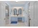 Charming blue bathroom with a vanity, two arched mirrors, and marble flooring at 578 Circle Dr., Myrtle Beach, SC 29575