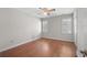 Bright bedroom with hardwood floors, ceiling fan, and two shuttered windows for natural light at 578 Circle Dr., Myrtle Beach, SC 29575