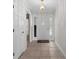 Bright foyer featuring decorative glass door inserts, neutral tile floors, and elegant chandelier at 578 Circle Dr., Myrtle Beach, SC 29575