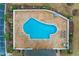 Aerial view of the community pool and patio area, surrounded by trees and parking at 5870 Longwood Dr. # 201, Murrells Inlet, SC 29576