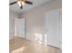 This bedroom offers neutral walls, hardwood floors, and a ceiling fan for added comfort at 5870 Longwood Dr. # 201, Murrells Inlet, SC 29576