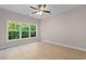 Sunlit bedroom with wood-look floors and a large window at 5870 Longwood Dr. # 201, Murrells Inlet, SC 29576