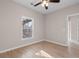 Bright bedroom features a window and hardwood floors, creating a warm and inviting space at 5870 Longwood Dr. # 201, Murrells Inlet, SC 29576
