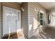 Close-up of a condo front door showing unit number, exterior siding and adjacent windows with green shutters at 5870 Longwood Dr. # 201, Murrells Inlet, SC 29576