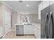 Modern kitchen with stainless steel appliances, white cabinets and light quartz countertops in an open concept layout at 5870 Longwood Dr. # 201, Murrells Inlet, SC 29576