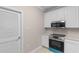 Well-equipped kitchen with white cabinetry, stainless steel appliances, and a full range of modern features at 5870 Longwood Dr. # 201, Murrells Inlet, SC 29576